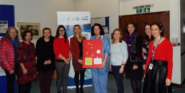 Image of hospital staff and Anne Sullivan centre staff holding training materials during deafblind awareness training.