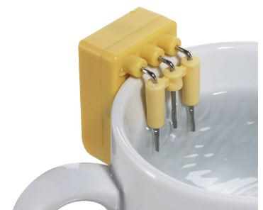 Yellow device sitting on mug with hooks which measure two levels